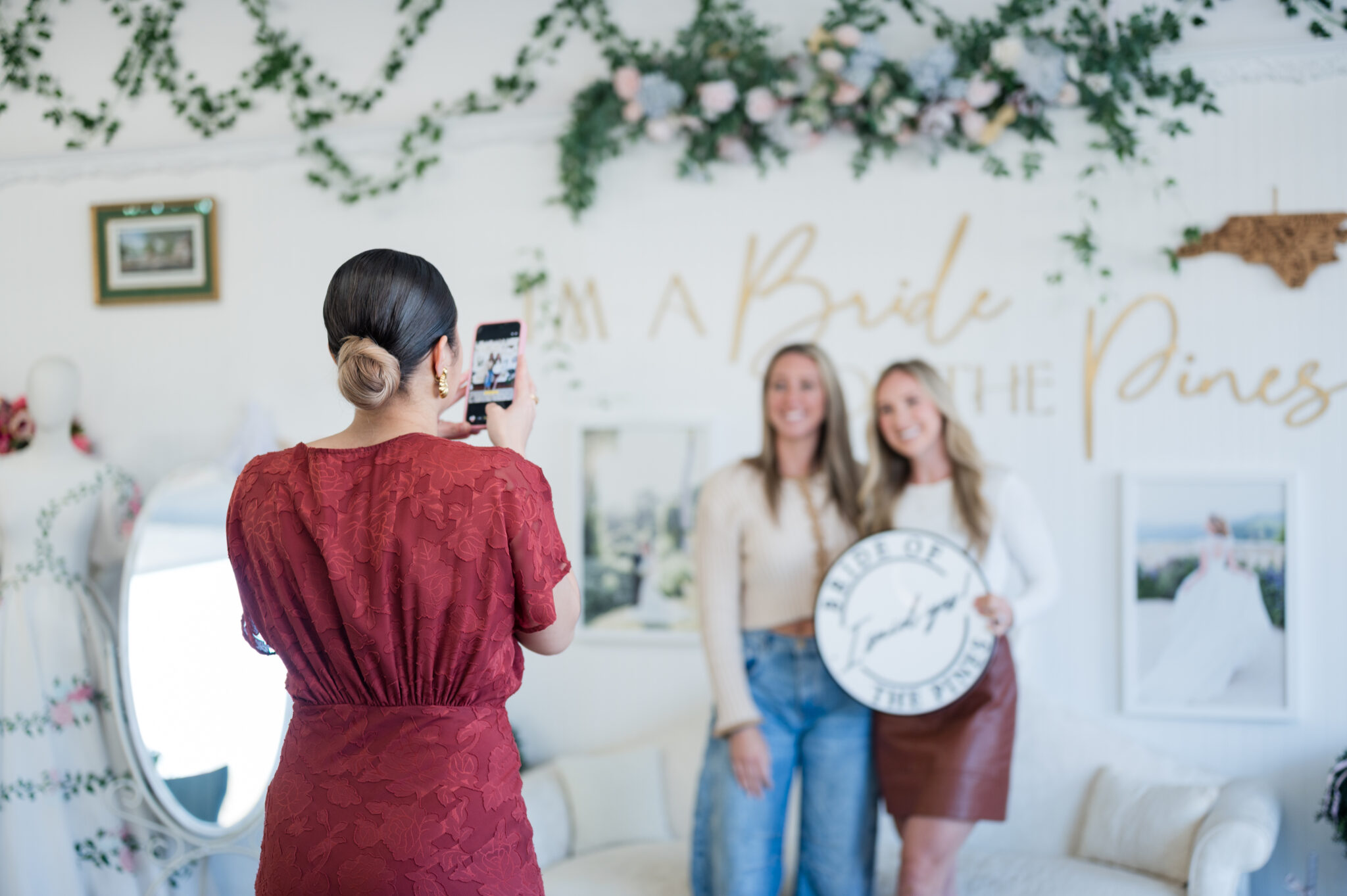 Bride taking yes photo after finding dream wedding dress at bride of the pines, fayetteville bridal store